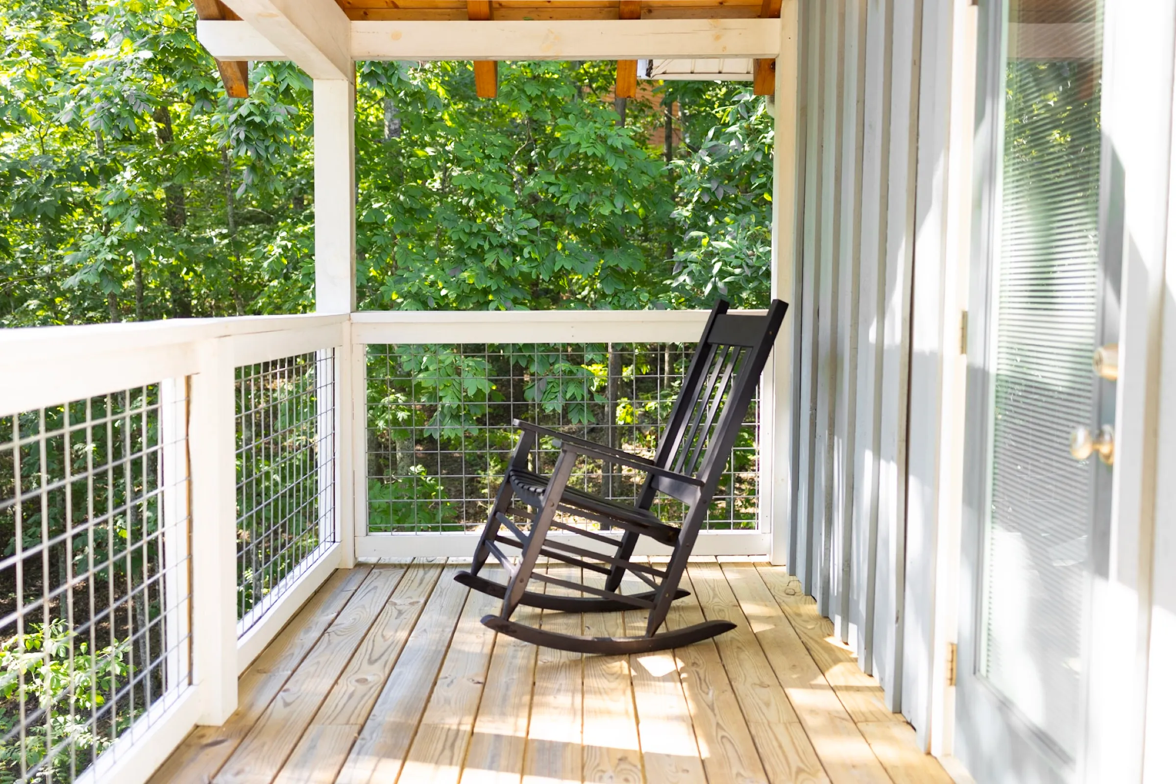 Screened porch with rocking chairs at Hygge Blue Chalet