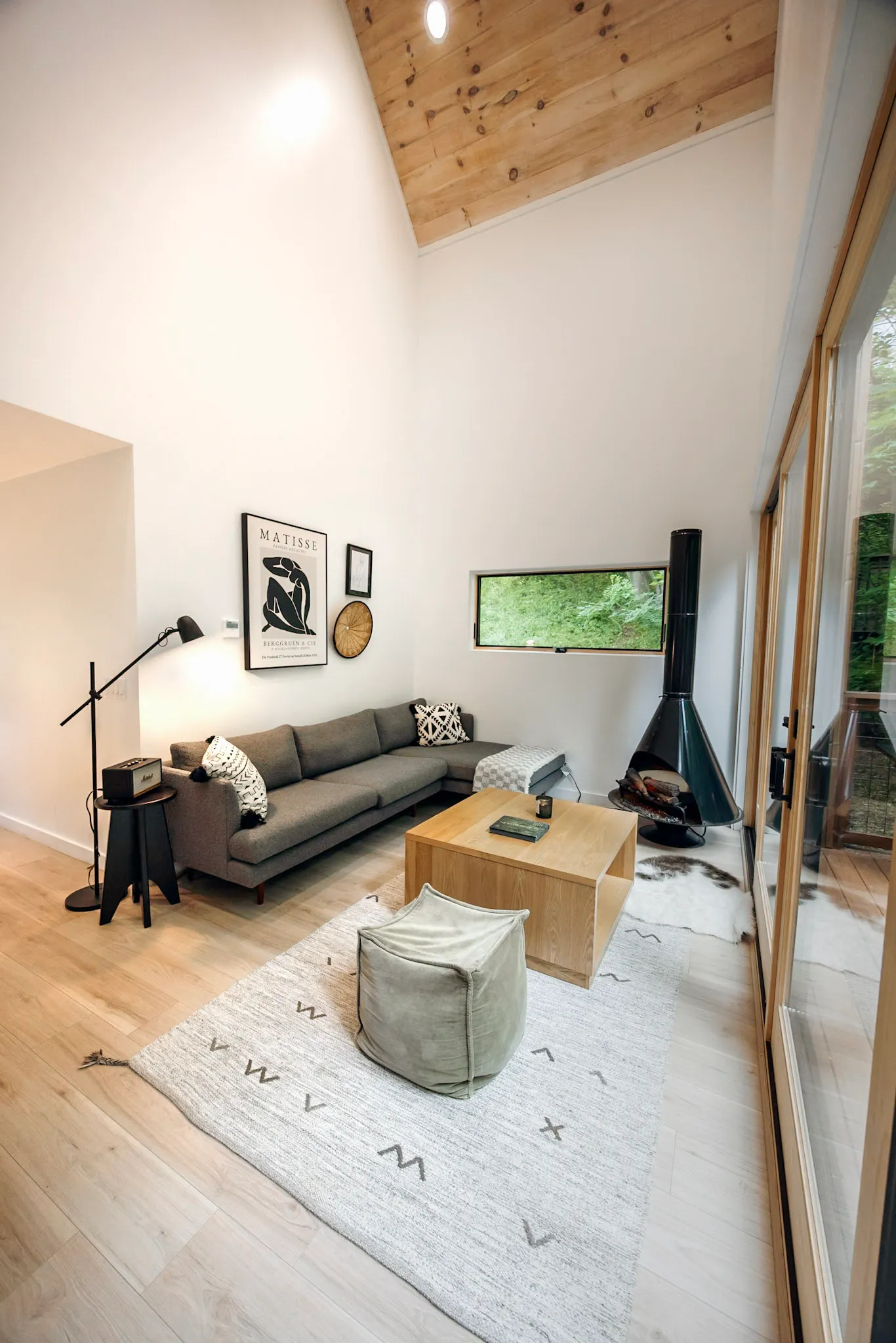 Living area vaulted ceiling with gallery wall and fireplace at Nordic Haus