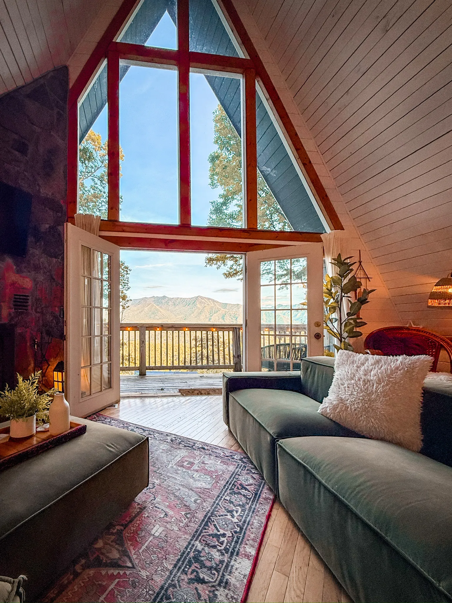 Living room with mountain view at golden hour at Little Green Cabin