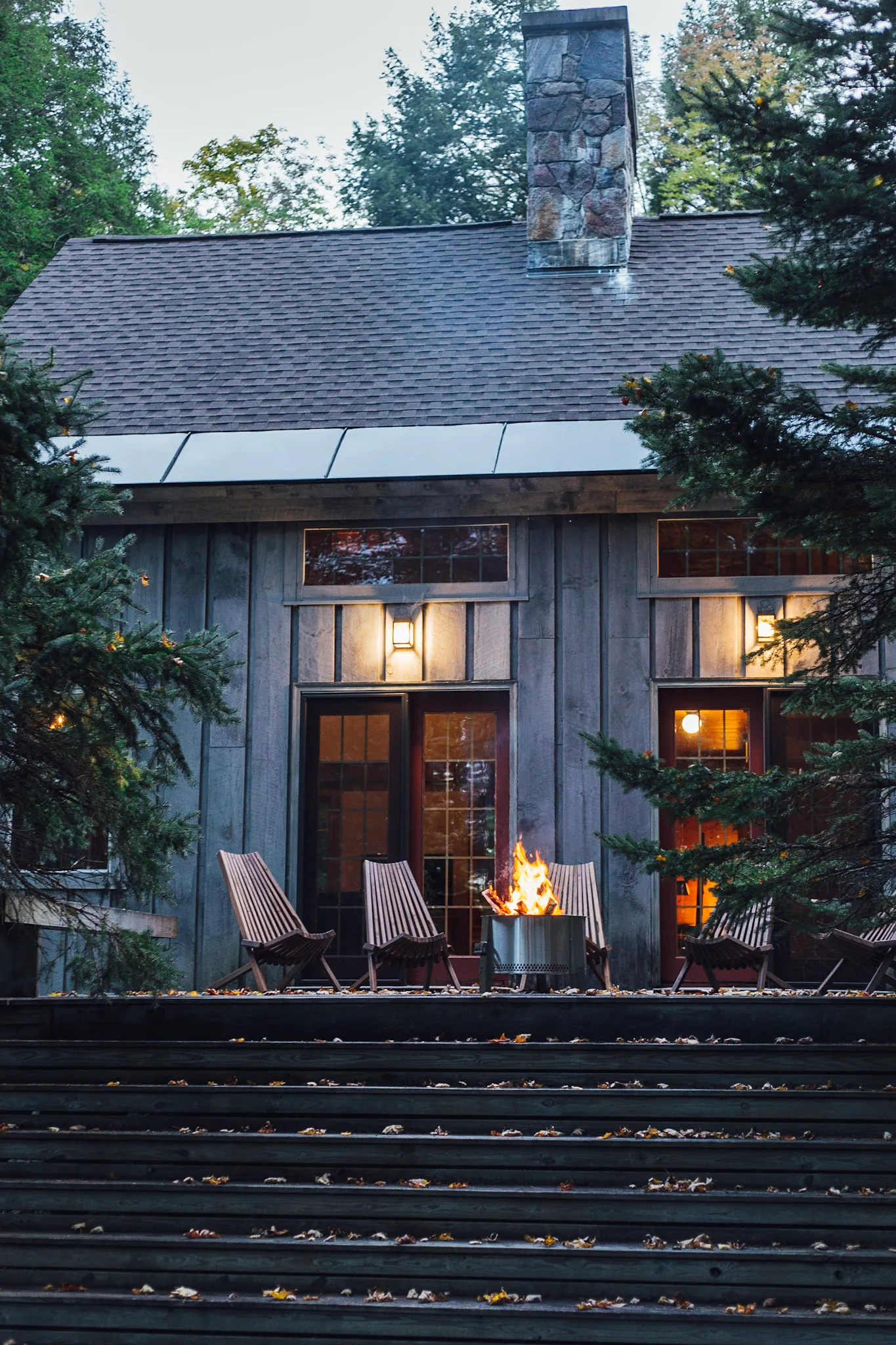 Dusk exterior framed by trees at Deerwood Hill