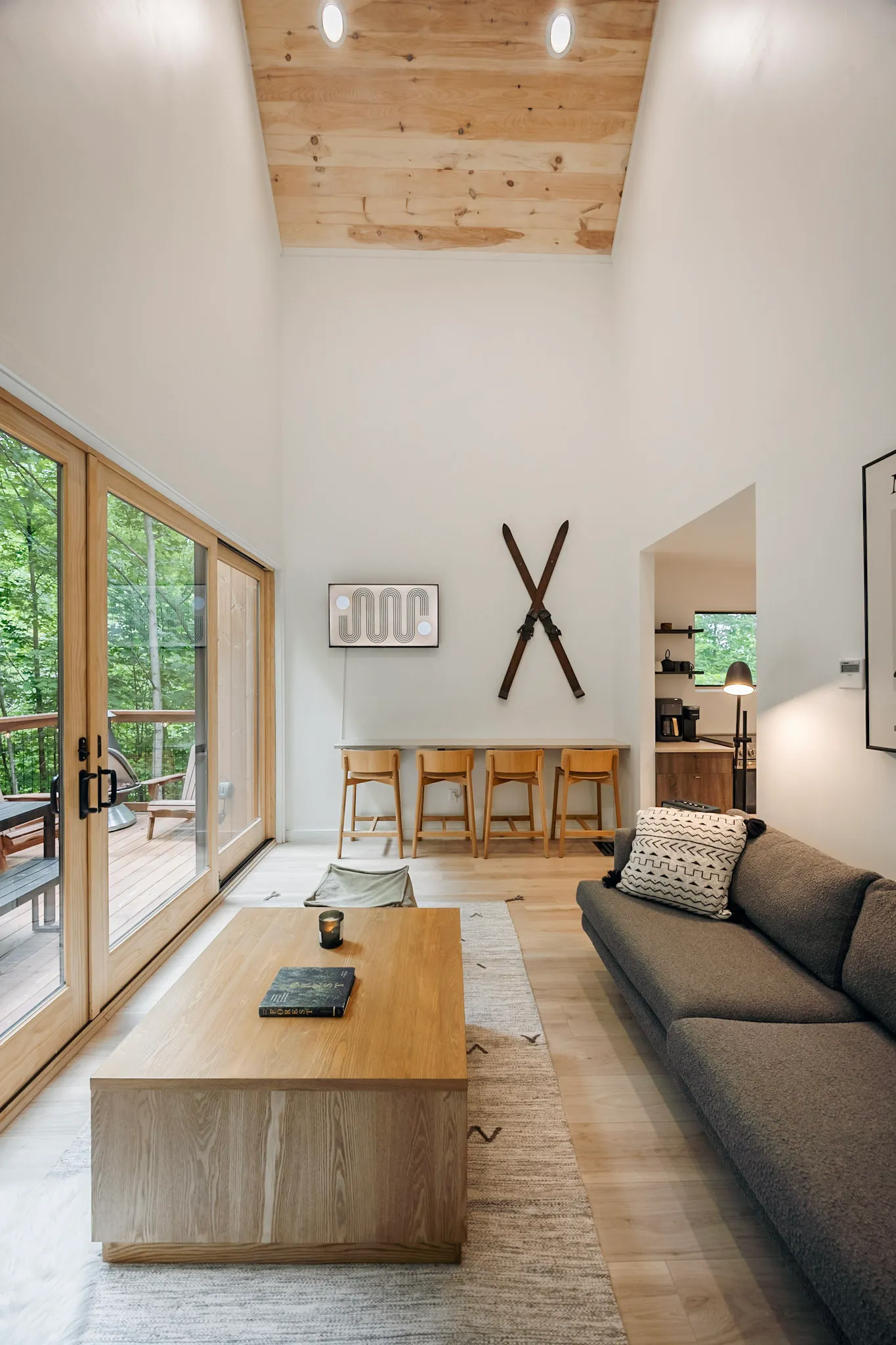 Living area sofa with ski wall art and view to dining bar at Nordic Haus