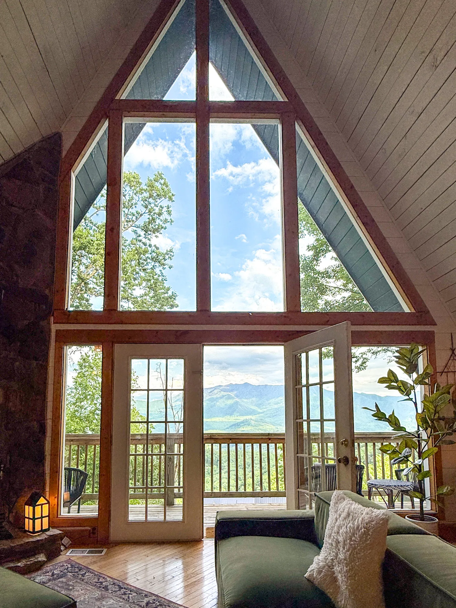 Tall A-frame glass wall framing mt leconte at Little Green Cabin