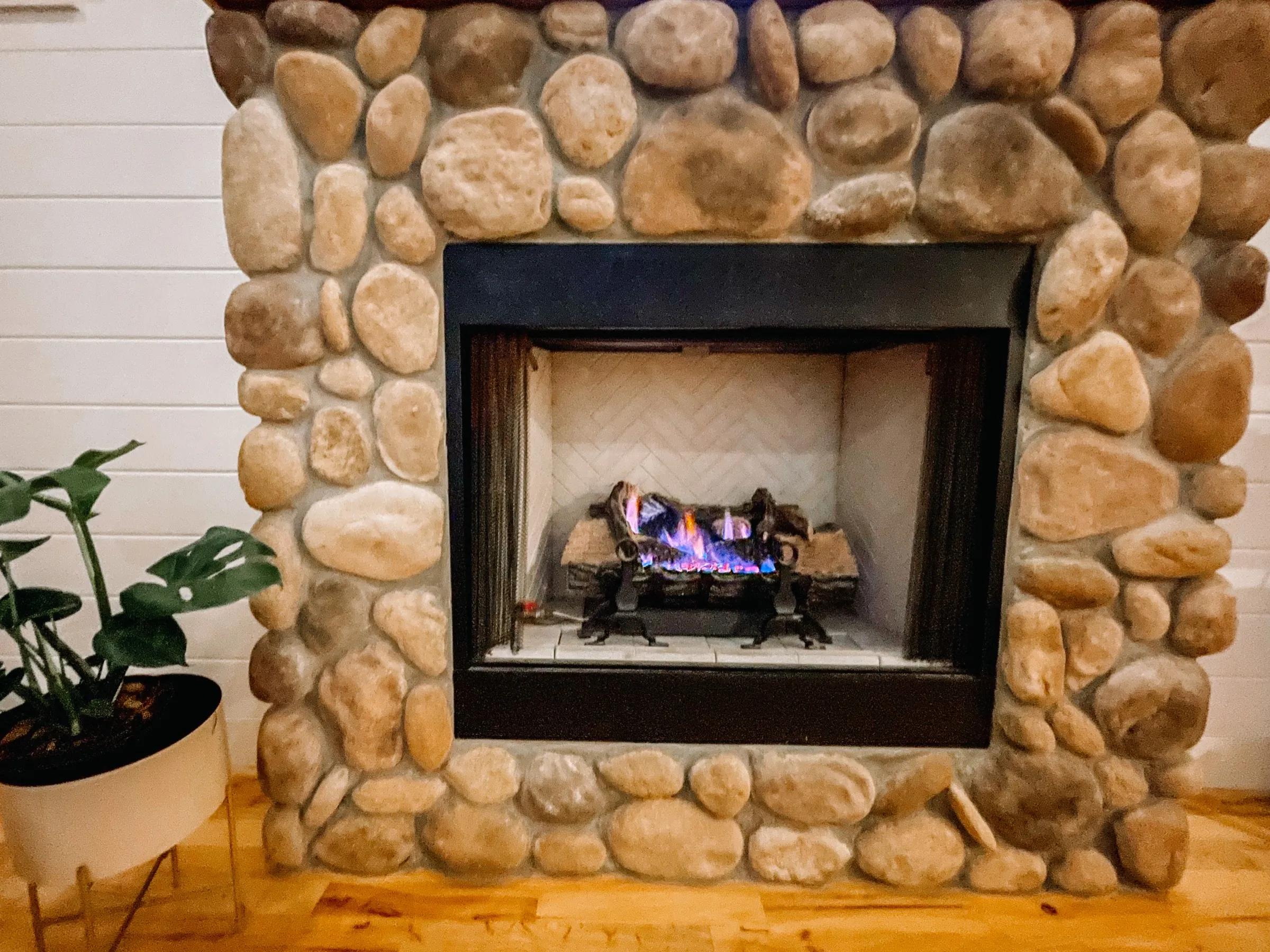 Stone fireplace sitting area at Sand Reef Cottage