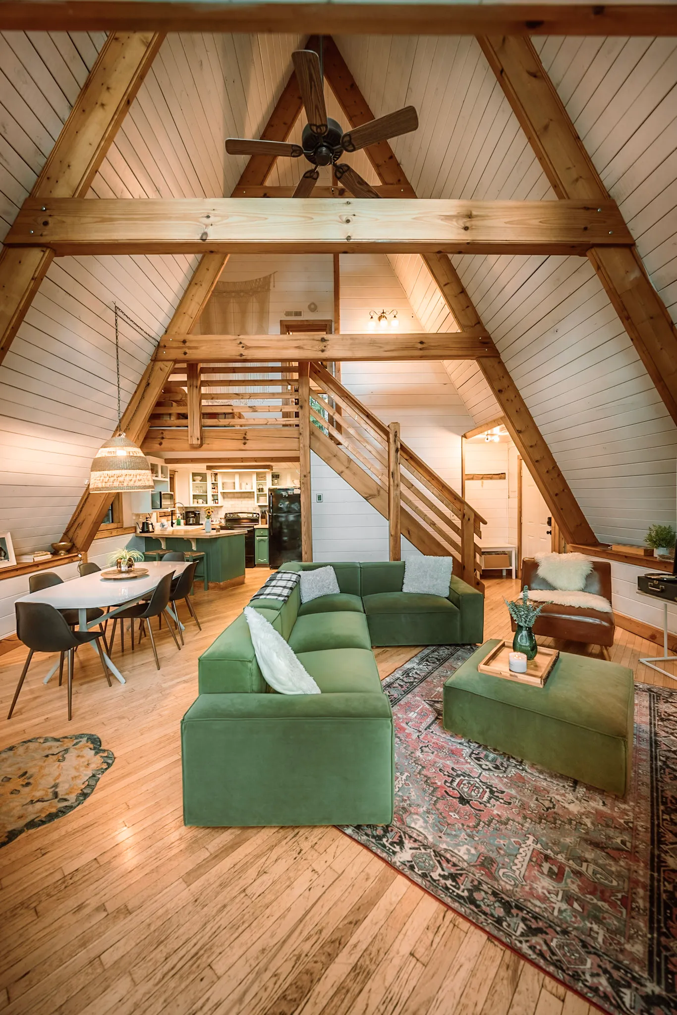 Open plan living room kitchen and staircase to the loft at Little Green Cabin