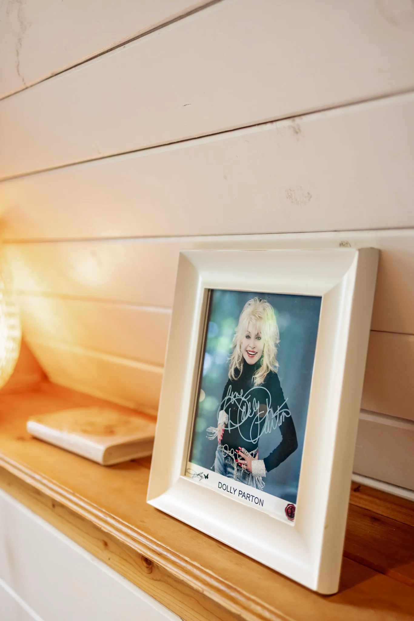 Dolly parton photo on the living room shelf at Little Green Cabin