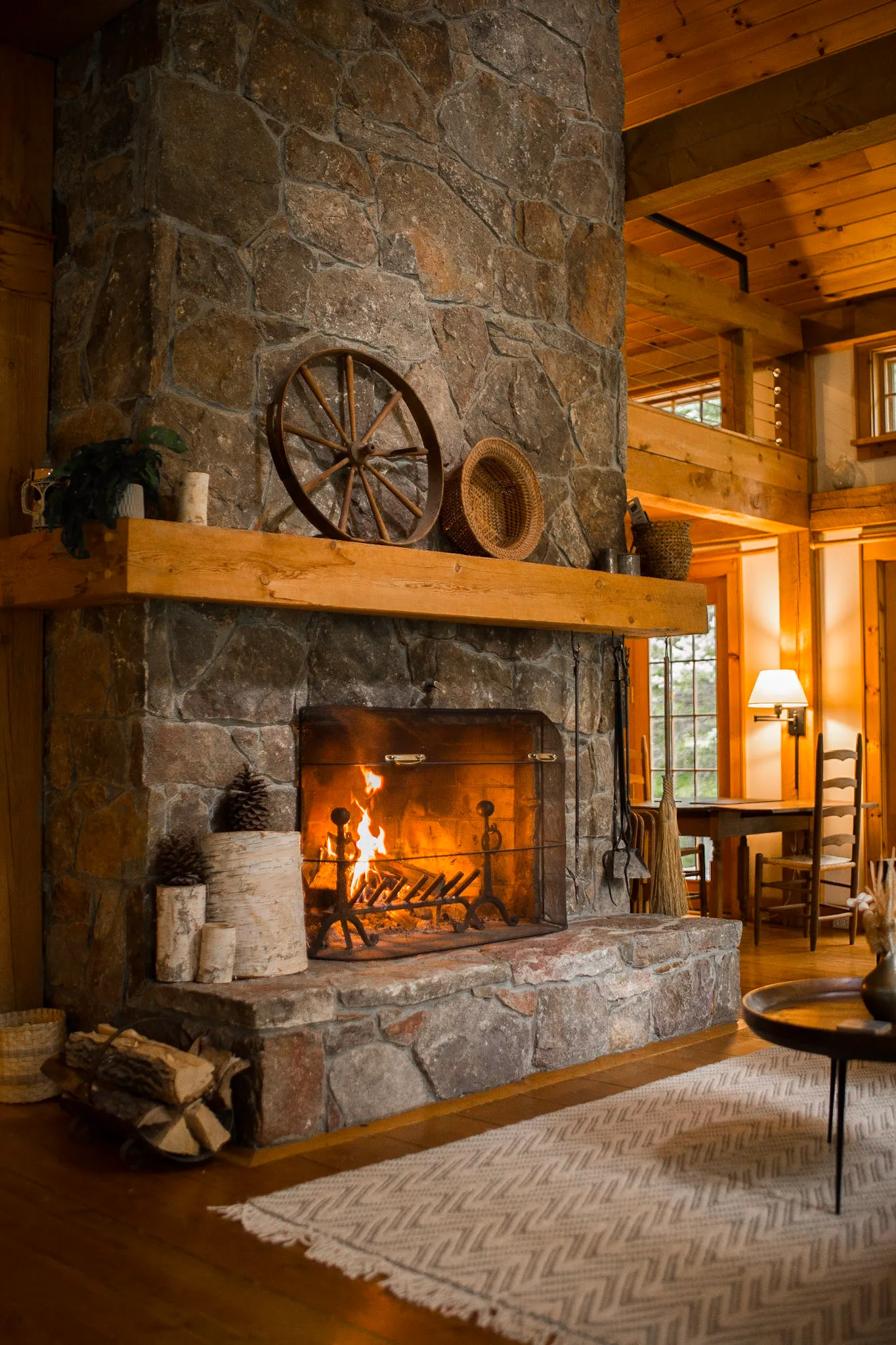 Stone fireplace mantle with wagon wheel at Deerwood Hill