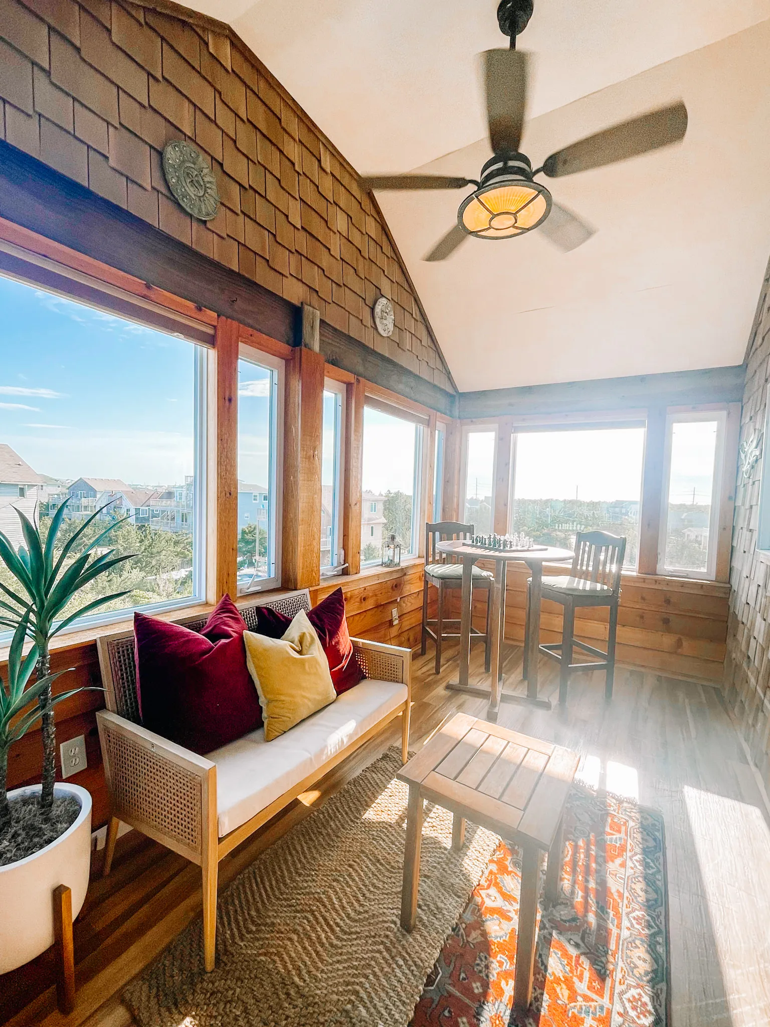 Cedar sunroom with cafe table at Dune Haus