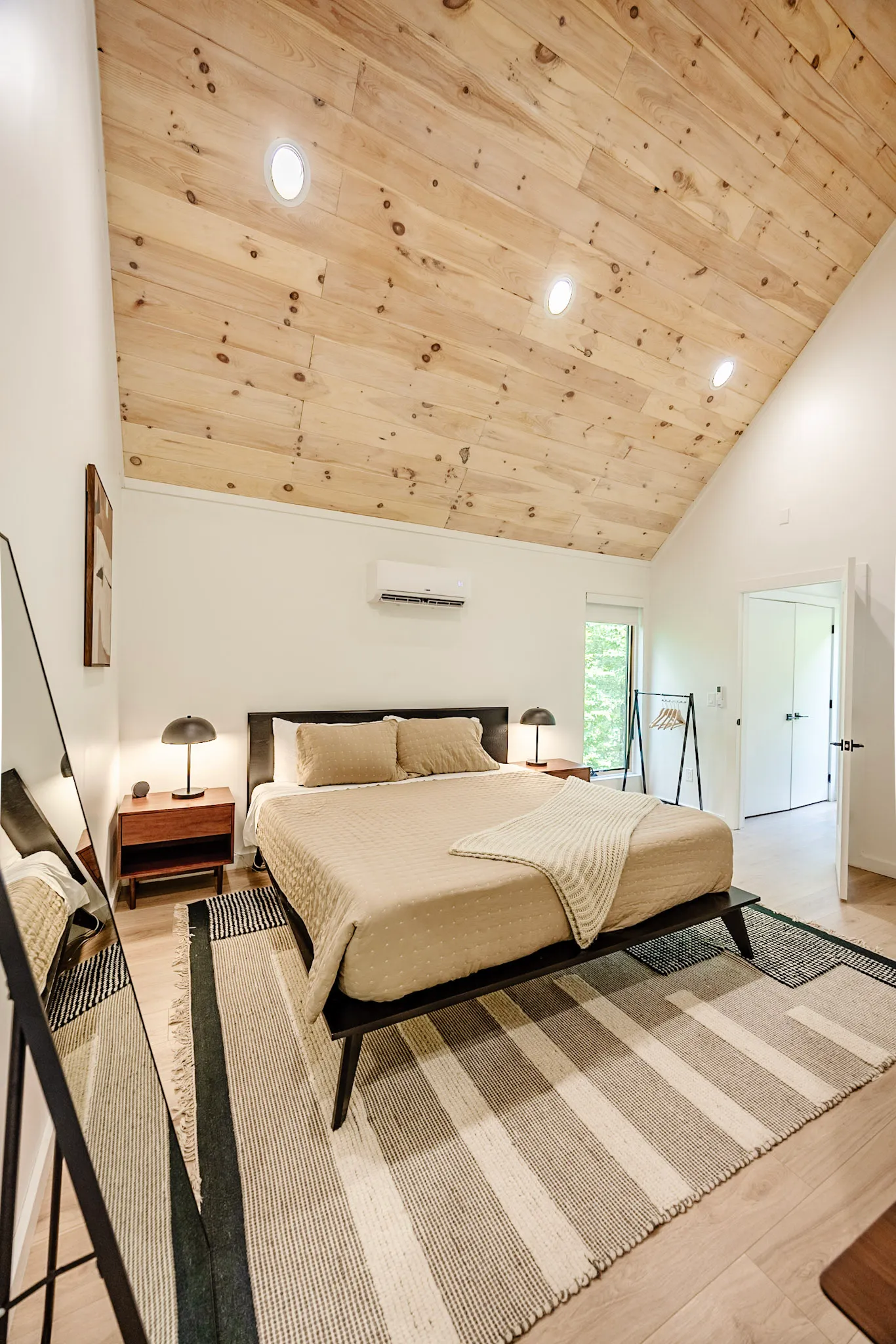 Main bedroom with king bed and vaulted wood ceiling at Nordic Haus