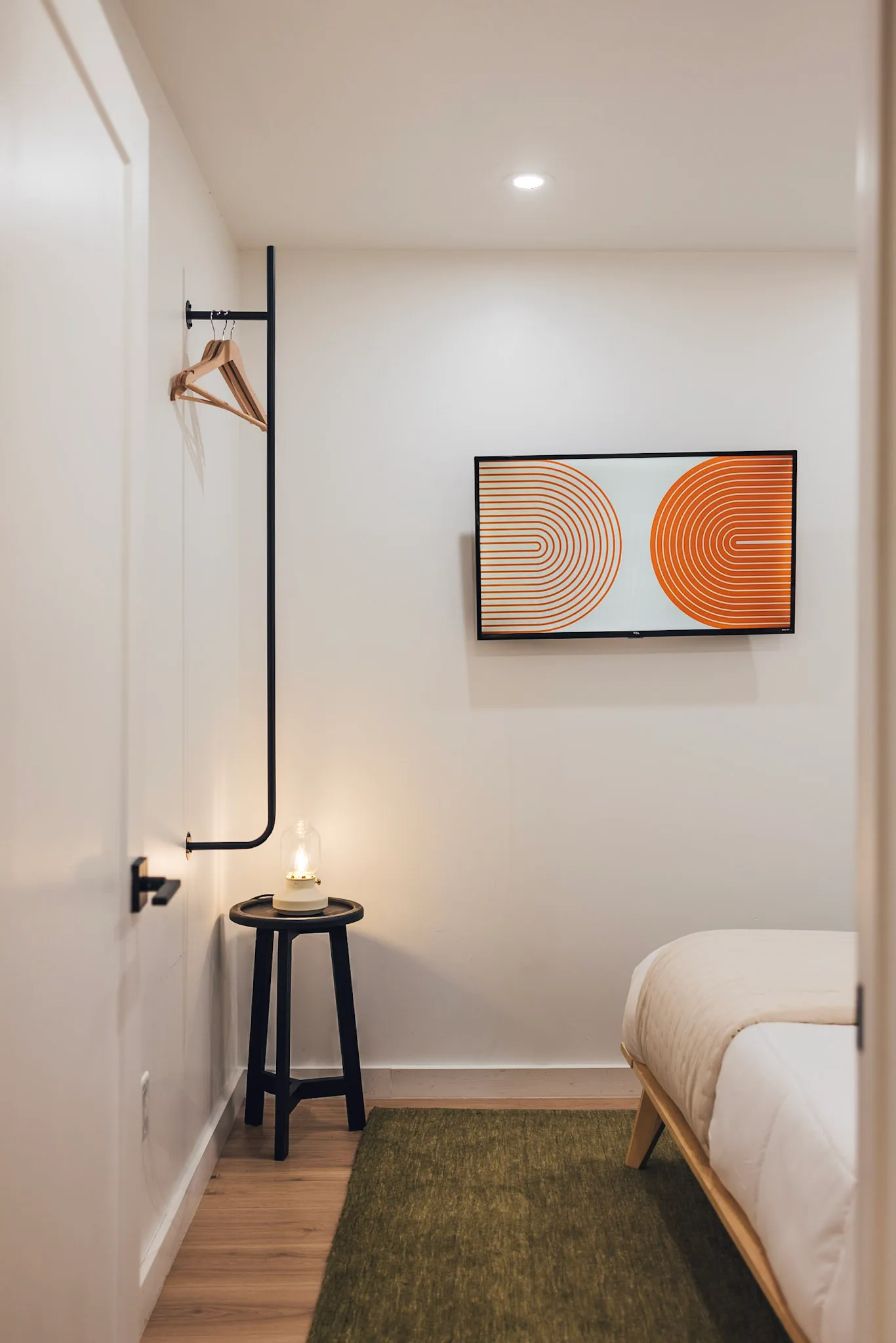 Lower bedroom corner with candle and abstract art at Nordic Haus