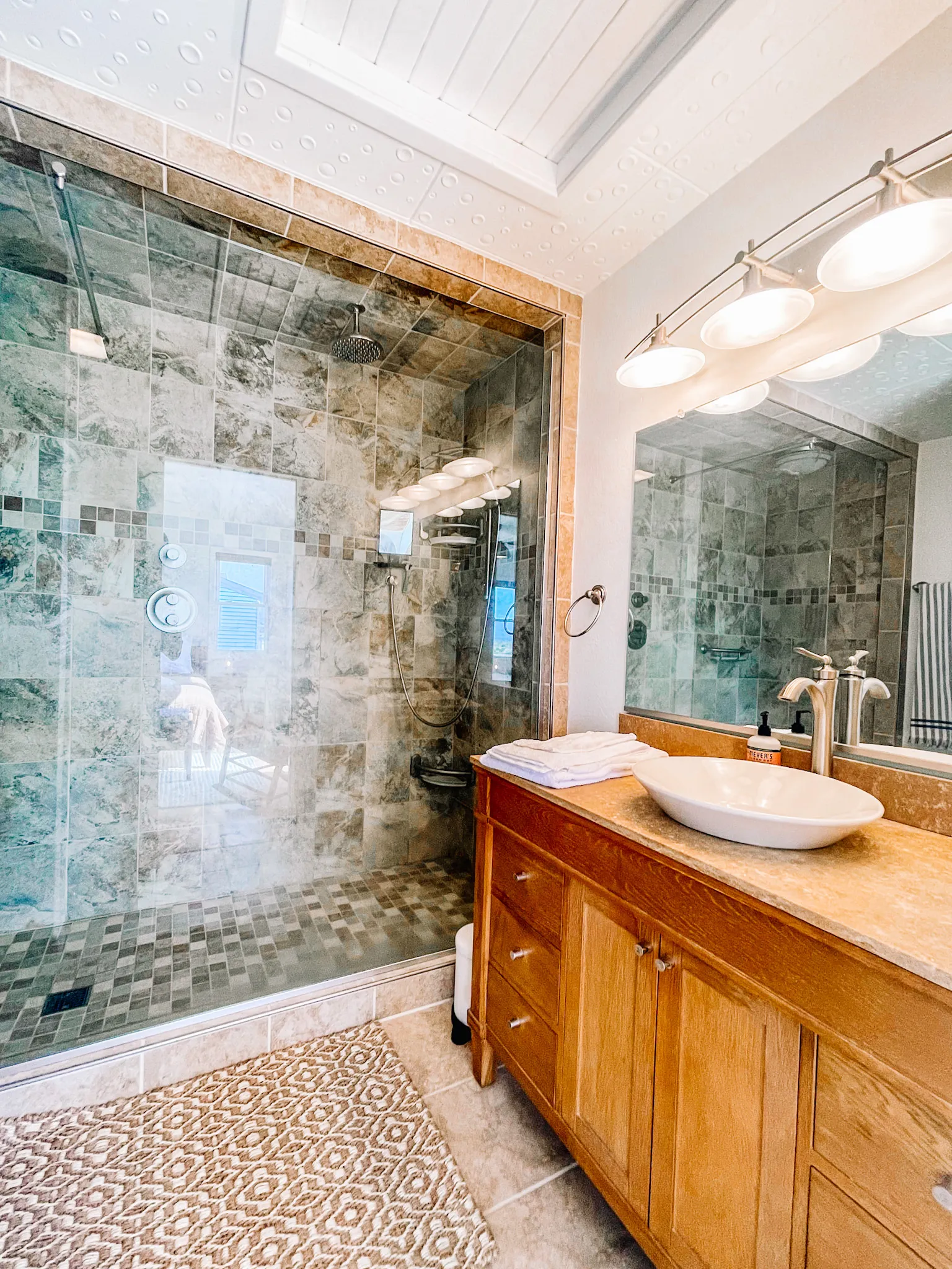 Bathroom with vessel sink and walk in shower at Dune Haus