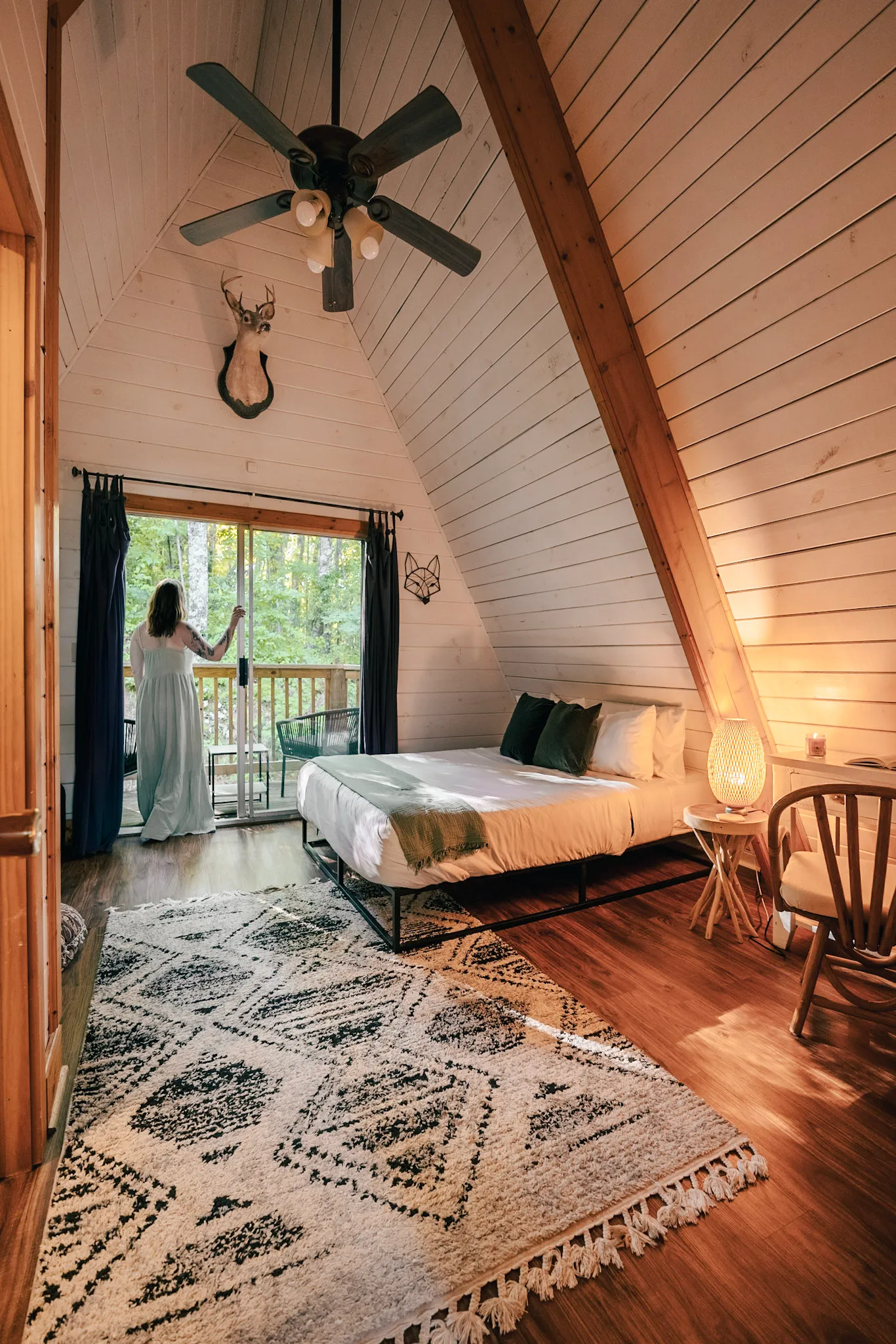 Queen bedroom with private balcony access at Little Green Cabin