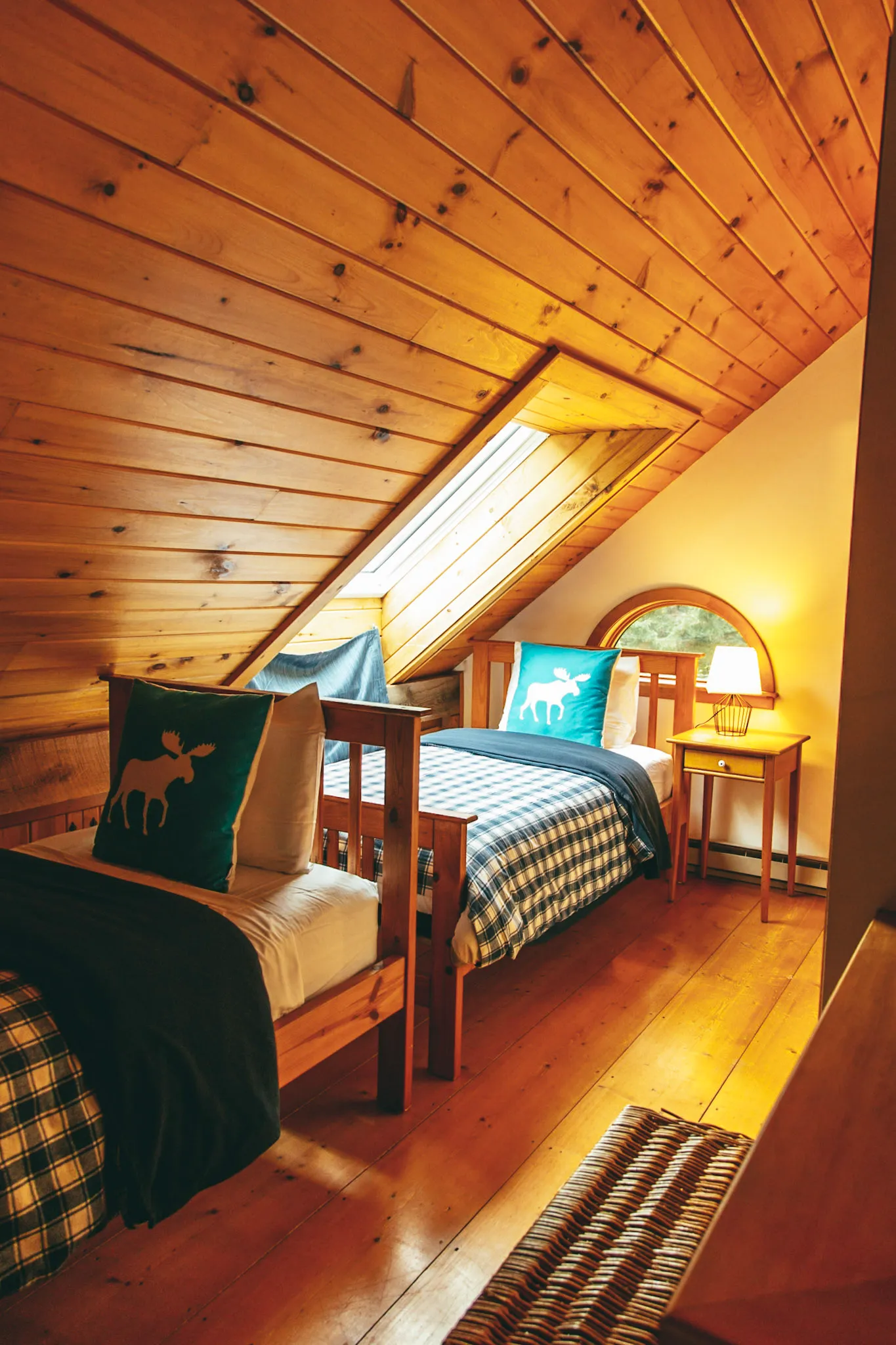 Bedroom two loft full bed with arched window at Deerwood Hill