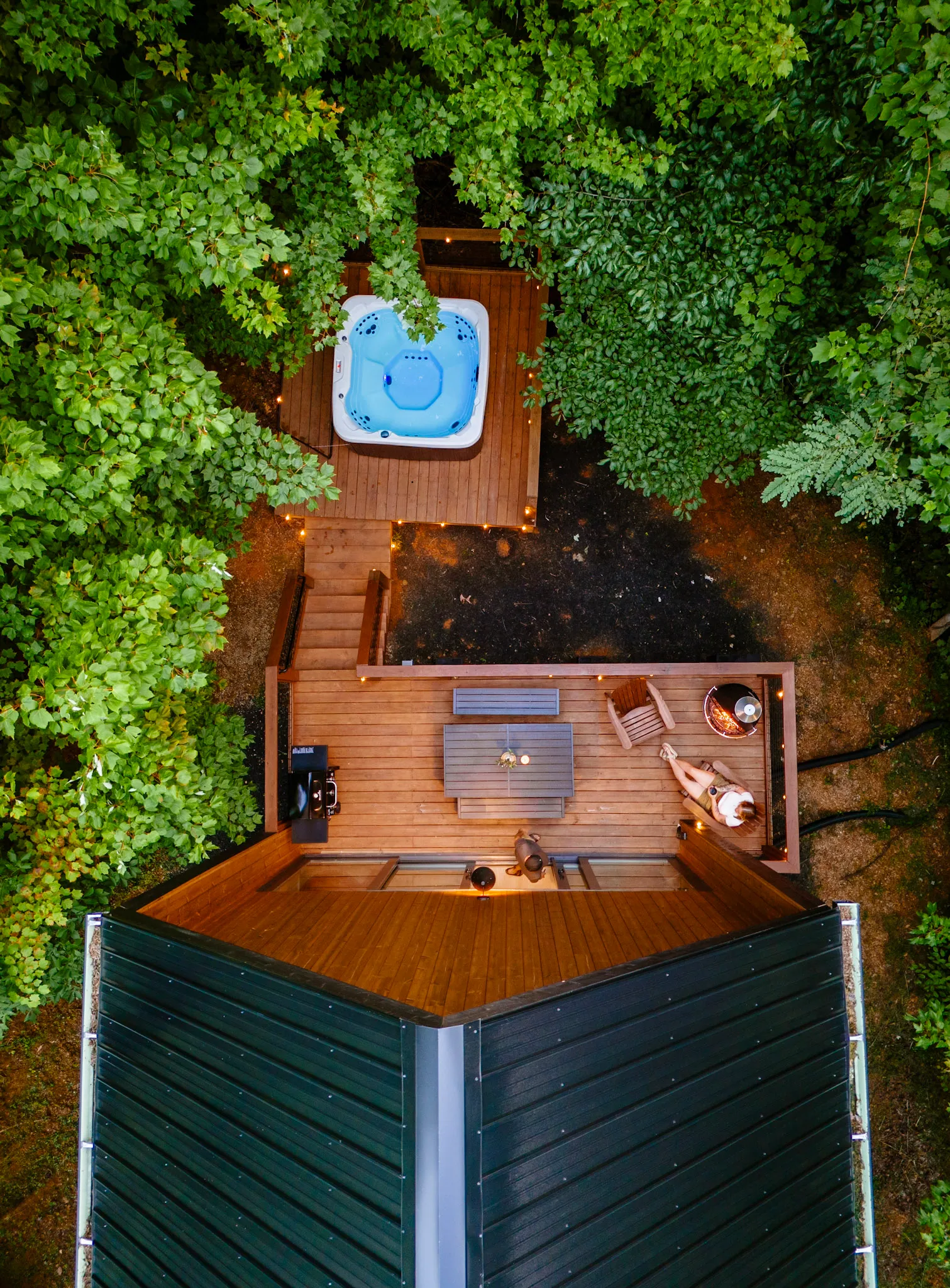 Aerial view of the hot tub and deck in the forest at Nordic Haus