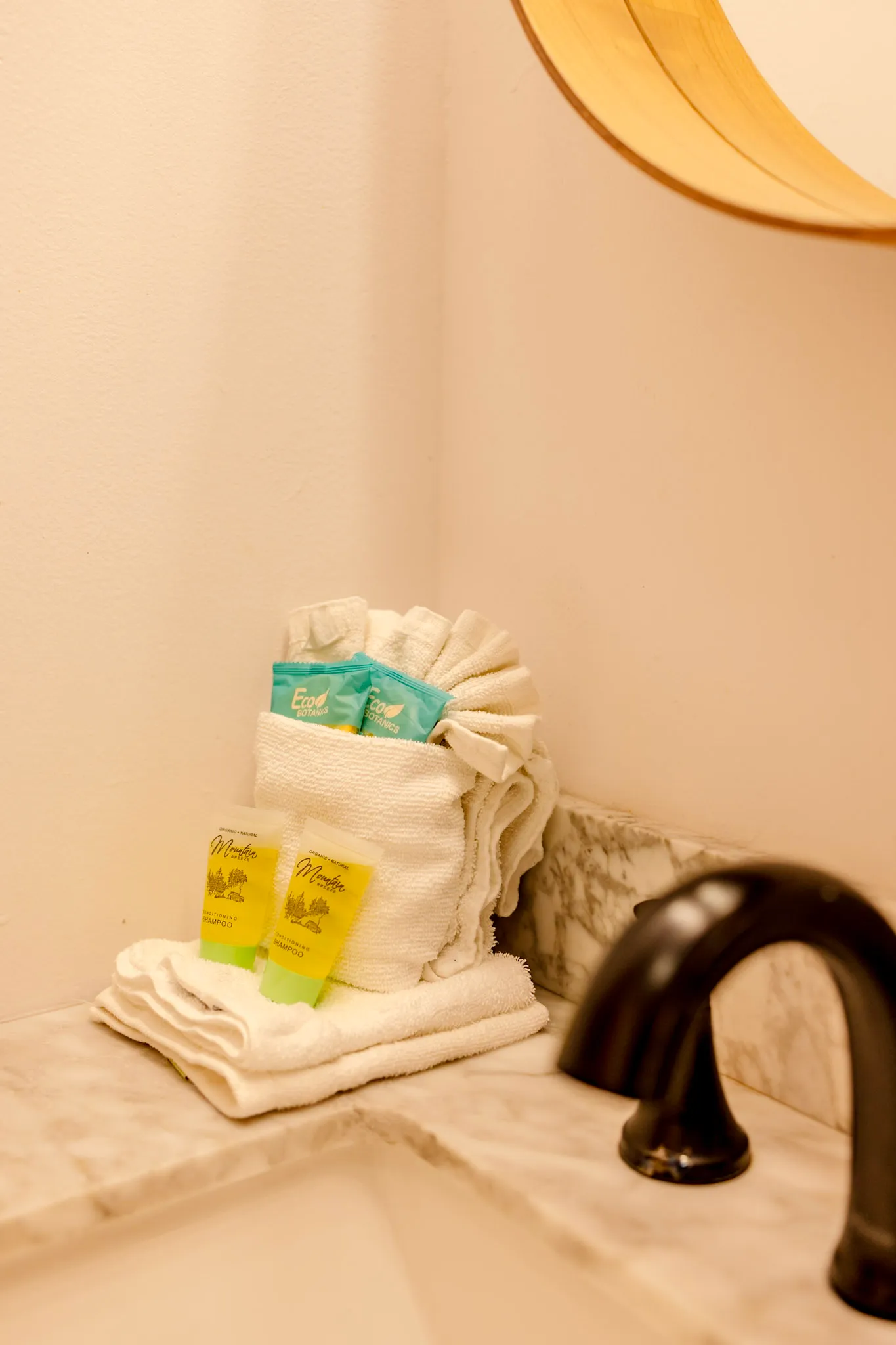 Towel and bath amenity detail on the marble vanity at Little Green Cabin