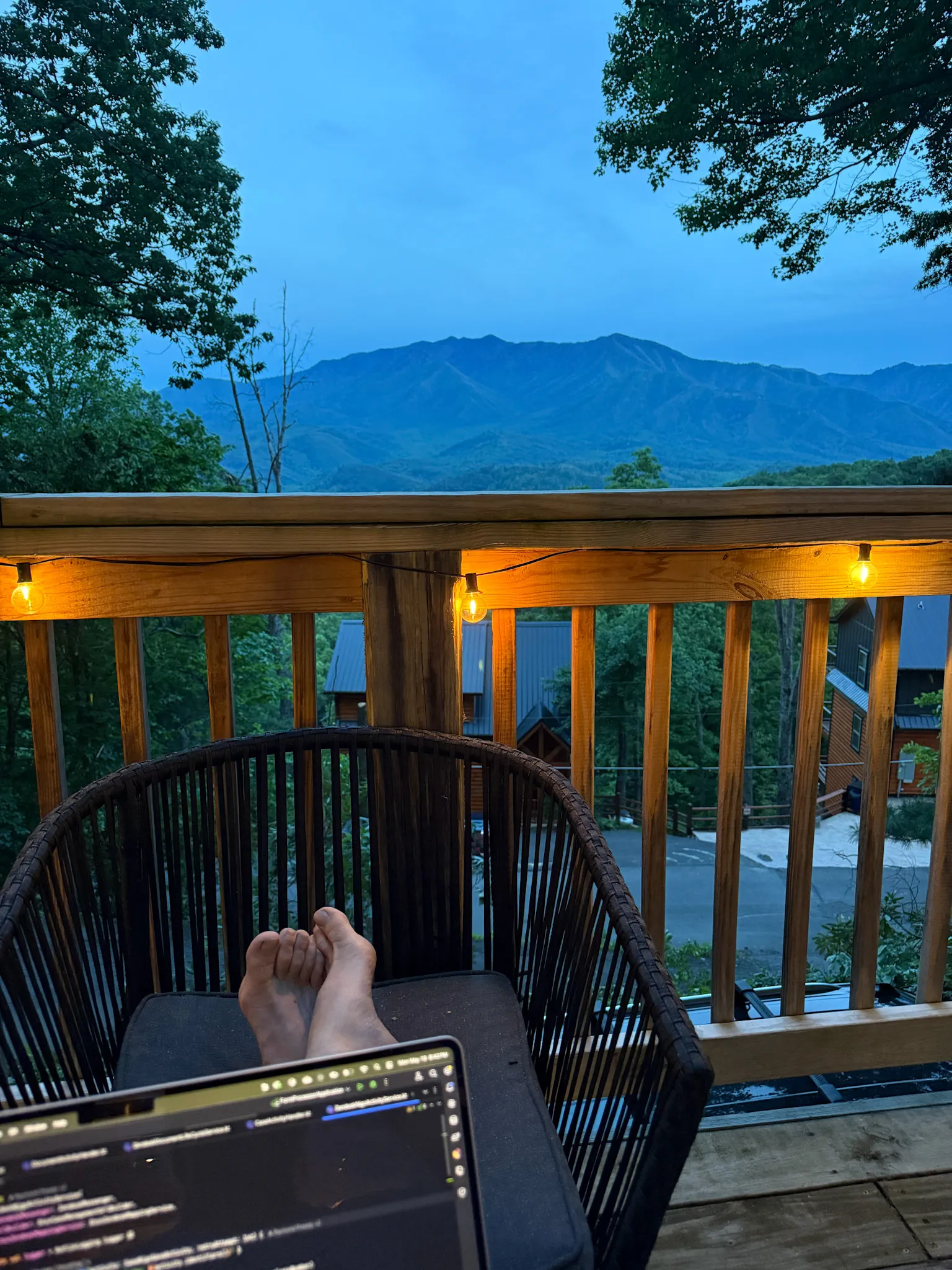 Deck evening with laptop and mountain silhouette at Little Green Cabin