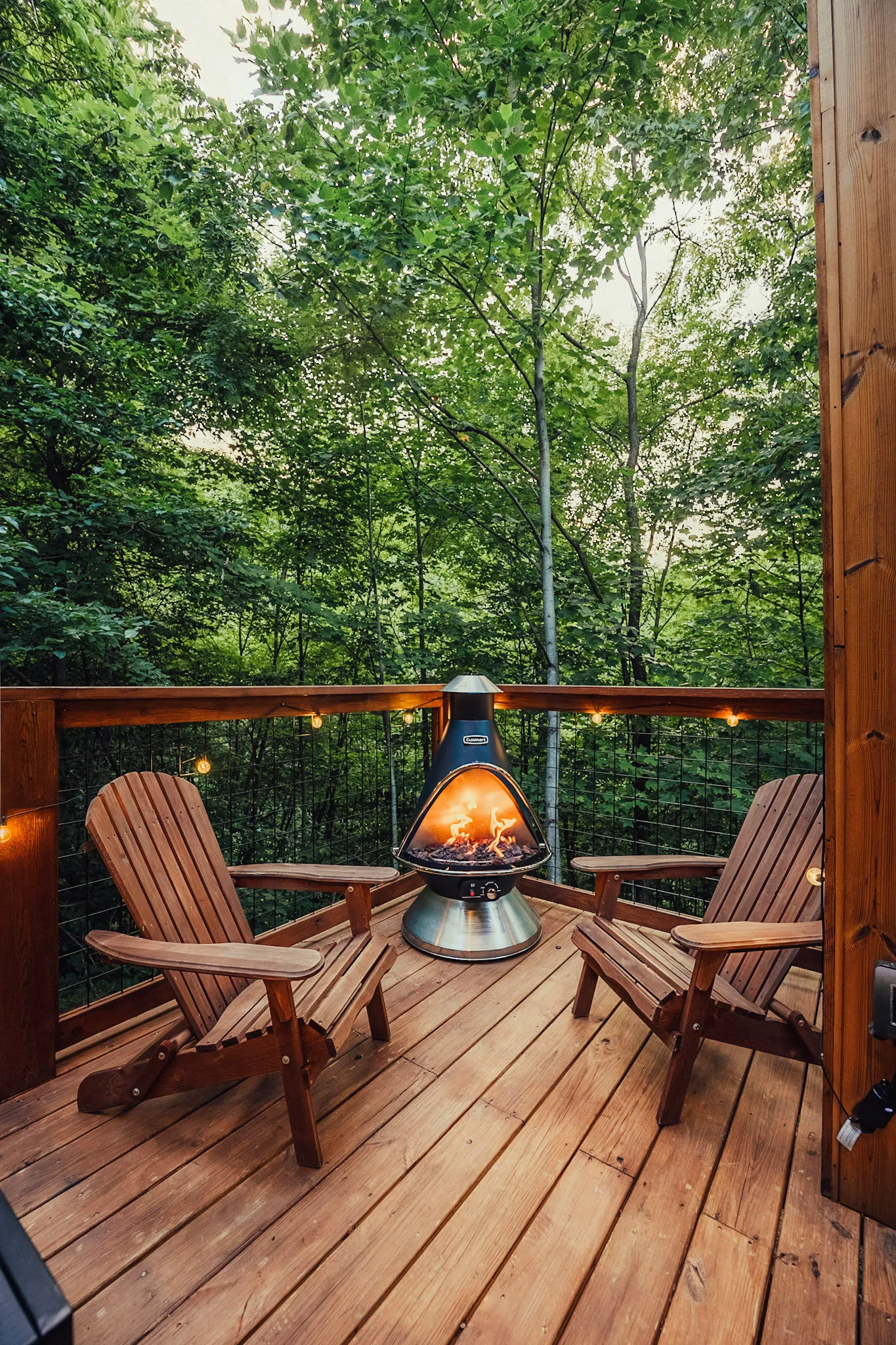 Deck fire pit flanked by adirondack chairs at Nordic Haus