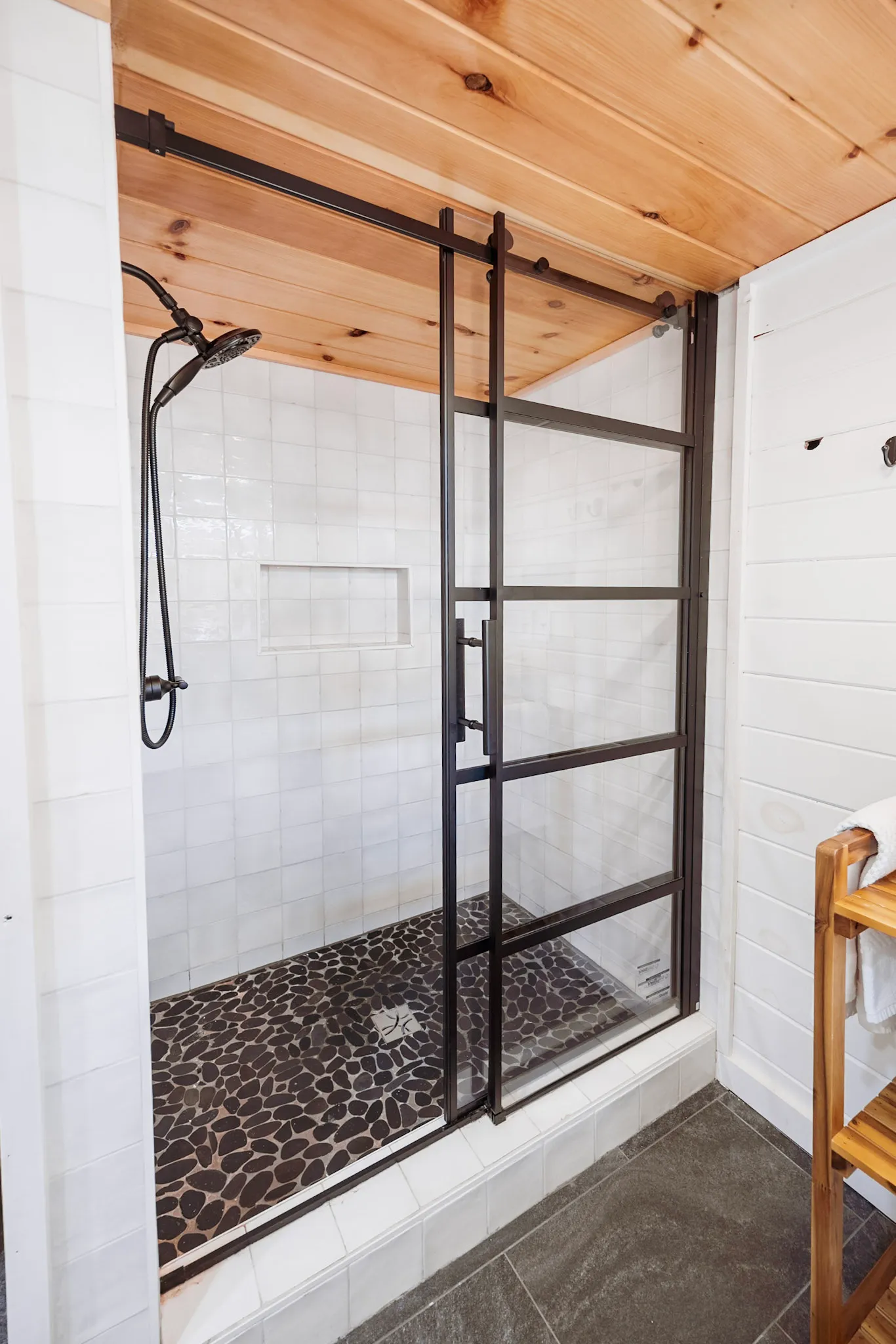 Bathroom two glass shower with pebble tile floor at Après Chalet
