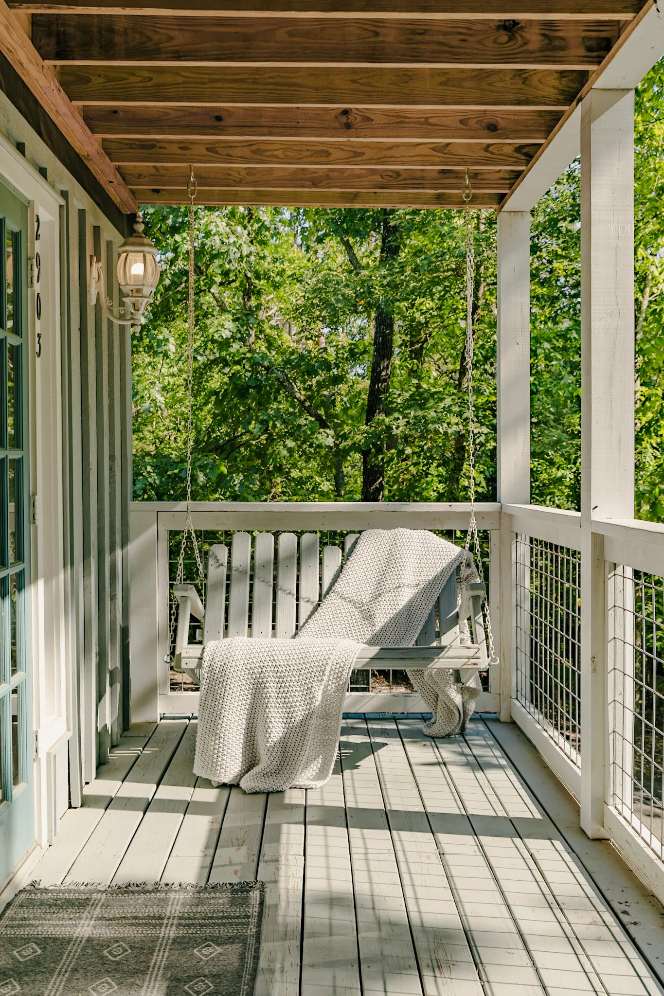 Front porch swing in daylight at Hygge Blue Chalet