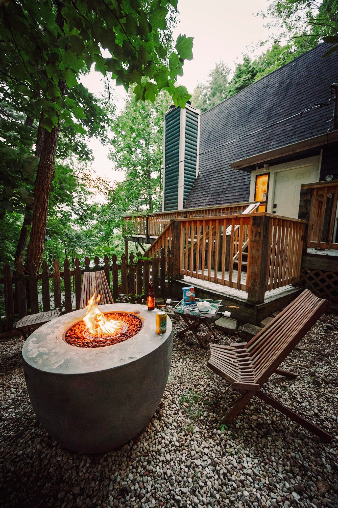 Propane fire pit lit at dusk at Little Green Cabin